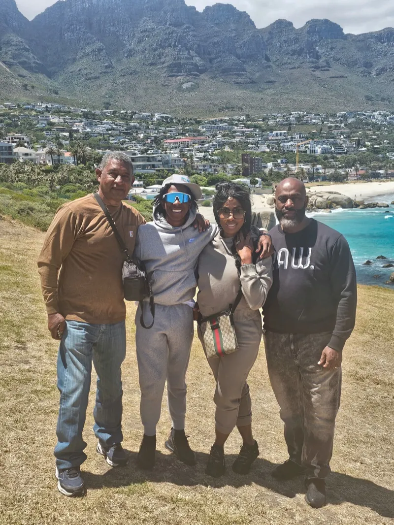 Four friends at a viewpoint above Camps Bay and the mountains
